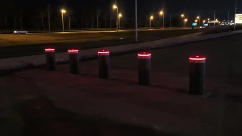 Lighted posts mark the entrance on a dark highway during nighttime travel Stock Footage 326375285