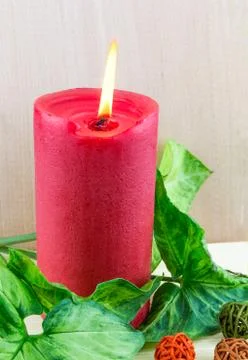 Lighted red candle Stock Photos