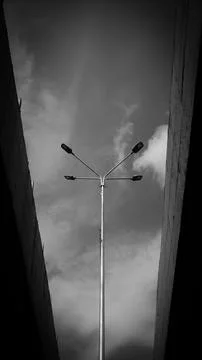 Lighted road pole between bridges in black and white photography Stock Photos