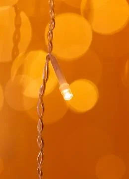 A lighted string of lights is hanging from a wire Foto stock