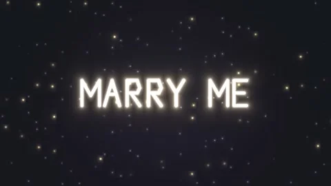 Lighted text with the message marry me in a night sky Stock Footage 339327647