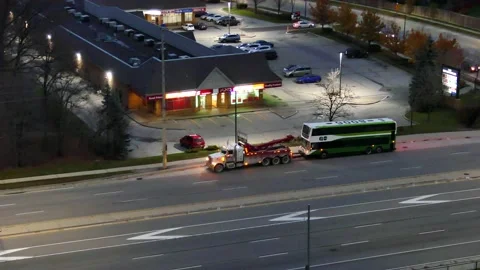 Lighted Tug vehcile reverse to the Broken Street Bus high angle Stock Footage 147232721
