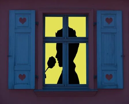 Lighted window frame with a silhouette of a romantic person smelling a rose,  Stock Photos