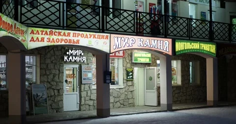 Lighted windows of small retail stores selling locally produced goods. 스톡 동영상 232981225