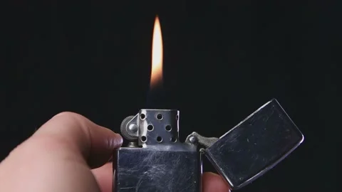 Lighter being lit on a black background Stock Footage 172409016