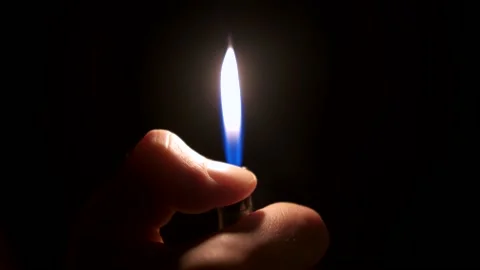 Lighter close-up during ignition. A small light in the dark Stock Footage 141710270