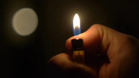 Lighter flame in the dark Stock Footage 123422713
