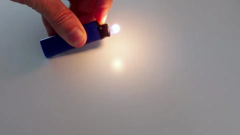 Lighter Ignition Macro: Flame Meets Minimalist Backdrop Stock Footage 318443229