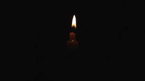 A lighter lighting a small candle in the dark. combustion process. Video stock 240563626