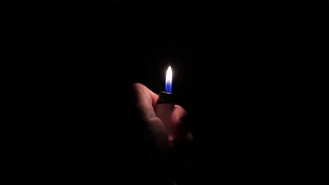 The lighter lights up in the dark Stock Footage 242806913