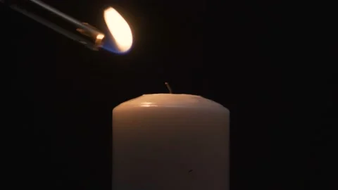 A lighter set fire to a large candle 4K Video stock 101079674