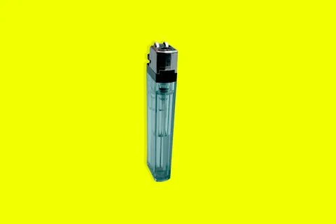 Lighter on a yellow background Stock Photos