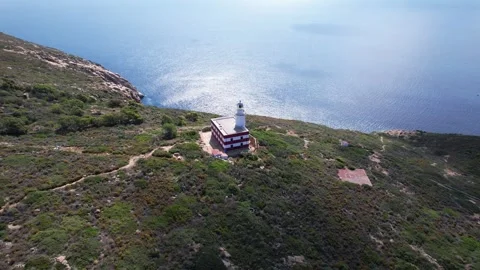 Lighthouse-Aerial orbit 4K drone view Capel Rosso Giglio Island Italy Stock Footage 244945769