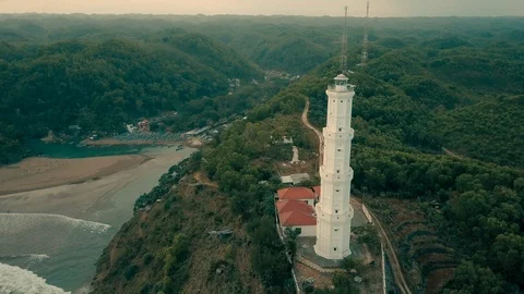 Lighthouse aerial view constructed over the hill located in beach, Indonesia Stock Footage 91879622