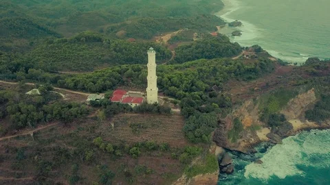 Lighthouse aerial view constructed over the hill located in beach, Indonesia Stock Footage 91880793