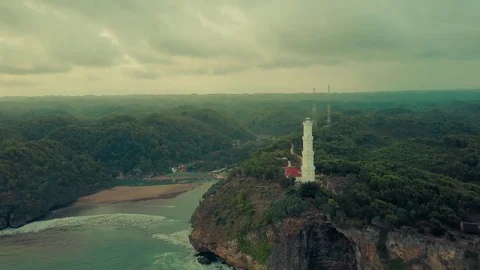 Lighthouse aerial view constructed over the hill located in beach, Indonesia Stock Footage 91880886