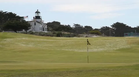 Lighthouse an American flag on golf course Stock Footage 21546982
