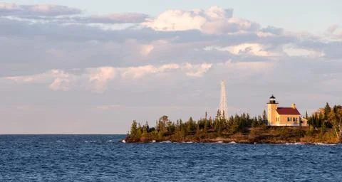 Lighthouse and Gathering Clouds in Evening Light Stock Photos