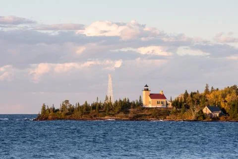 Lighthouse and Gathering Clouds in Evening Light Stock Photos