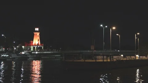 Lighthouse and harbour at night Stock Footage 117461358