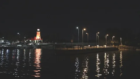 Lighthouse and harbour at night Stock Footage 117461385