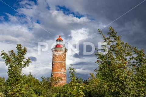Lighthouse and house in the Baltic Sea. Shore, evening light, sunset, clouds Stock Photos