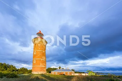 Lighthouse and house in the Baltic Sea. Shore, evening light, sunset, clouds Stock Photos
