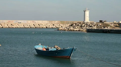 Lighthouse and lonely boat Stock Footage 60646291