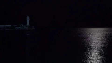 A lighthouse and a lunar path floating boat with beautiful lighting Stock Footage 115315186