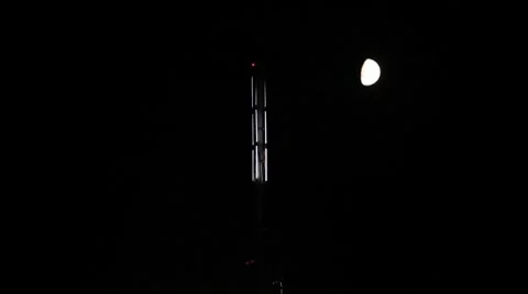 Lighthouse and moon in the night sky Stock Footage 8652545