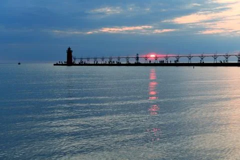 Lighthouse and Pier at Sunset Stock Photos