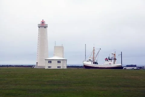 Lighthouse and ship on a clouds day in Iceland Stock Photos