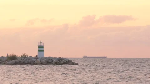 Lighthouse and the ship in the sunset Stock Footage 218985732