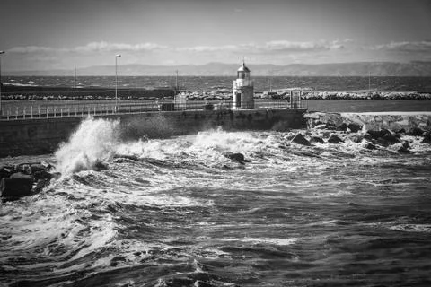 Lighthouse and waves on Adriatic sae in city of Trani, region Puglia, Italy Stock Photos