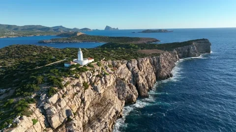 Lighthouse Atop A Steep Cliff Overlooking the Ocean in Ibiza Stock Footage 217365693
