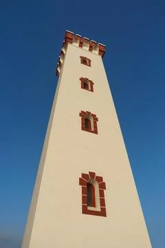 Lighthouse on the background of blue sky Stock Photos