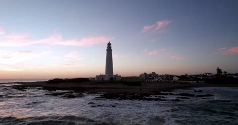 Lighthouse backlit. the sun is already hiding on the horizon. Stock Footage 260965422