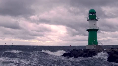 Lighthouse on baltic sea - storm, ocean, sprays, waves, clouds, wind - real time Stock Footage 141142302