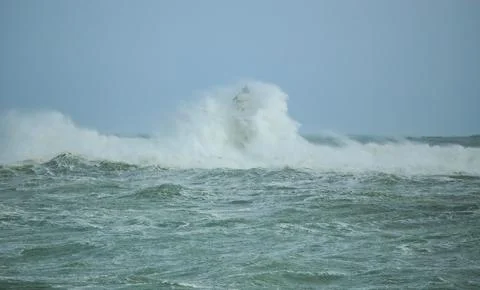 Lighthouse Battling Storm Waves in Open Sea Stock Photos