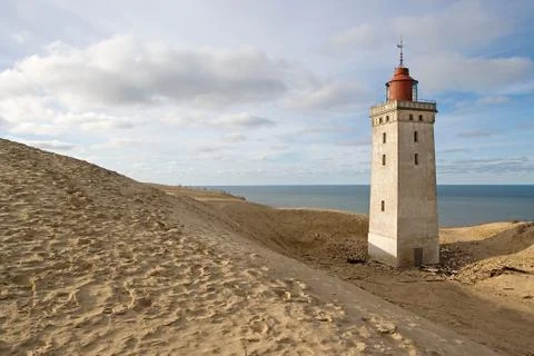 A lighthouse on a beach Stock Photos