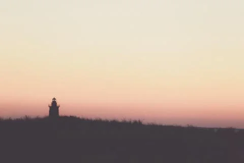 Lighthouse beach sunset silhouette Stock Photos