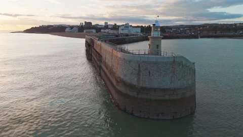 Lighthouse at a beach in the UK in the sunset Stock Footage 303289582