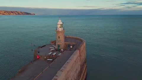 Lighthouse at a beach in the UK in the sunset Stock Footage 303289607