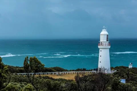 Lighthouse beacon at the coast of the ocean Stock Photos