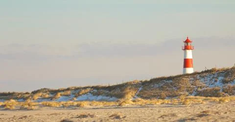 Lighthouse behind a dune LT Stock Photos