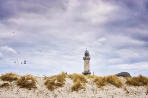Lighthouse behind the dunes in Warnemünde. Stock Photos