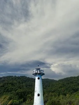 Lighthouse behind the rainforrest Stock Photos