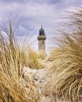 Lighthouse between dune grass. Rostock, Warnemunde, Germany Stock Photos