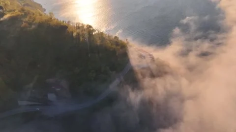 Lighthouse Between Sea Fog and Golden Sunset Coastal Reveal Video stock 339323552