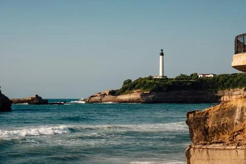 The lighthouse of Biarritz observing the waves Stock Photos